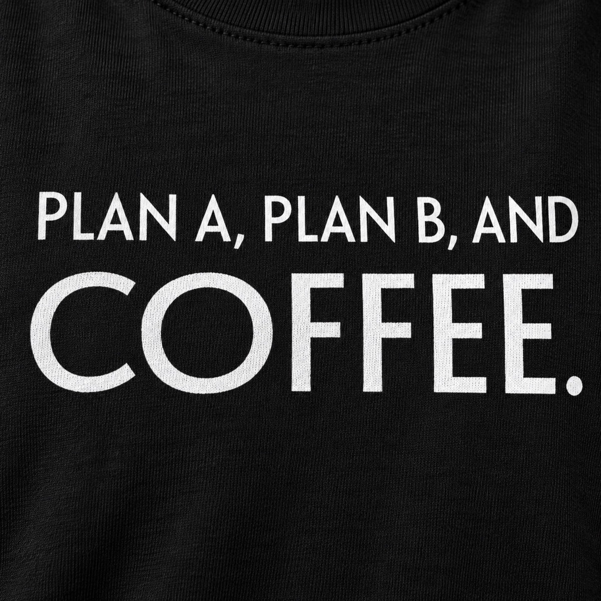 Close-up of Plan A, Plan B, and Coffee white lettering on black cotton