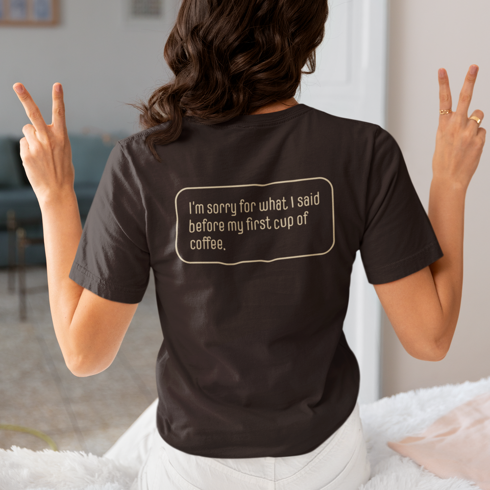 Coffee People — charcoal tee worn back to camera, back print reading “I’m sorry for what I said before my first cup of coffee”