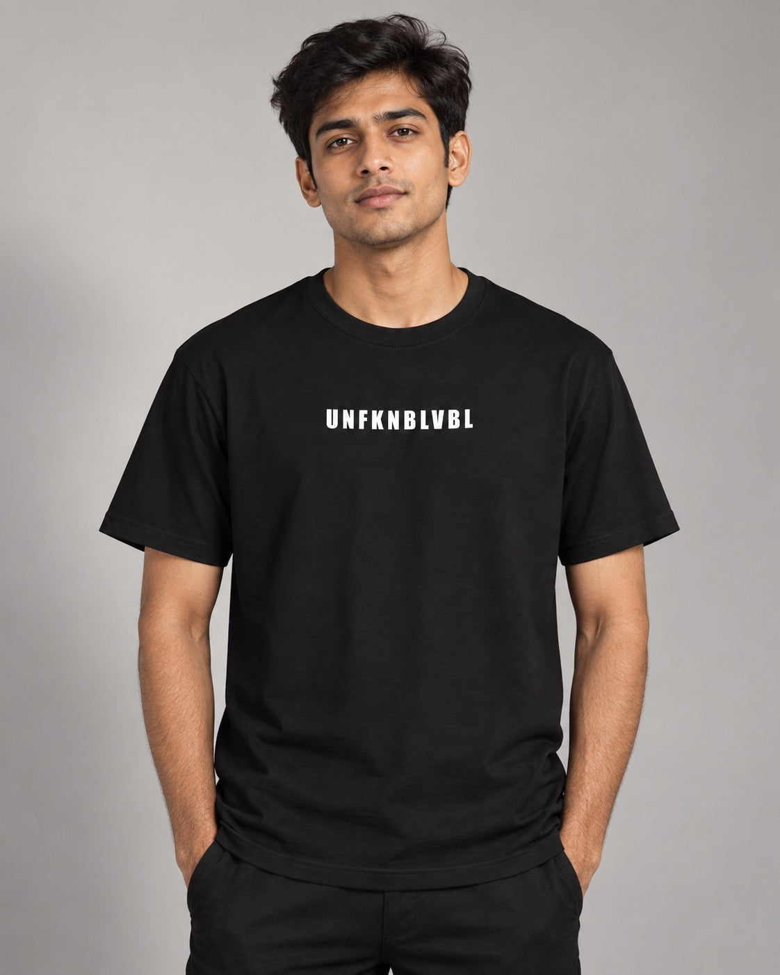 UNFKNBLVBL black text tee on male model, front