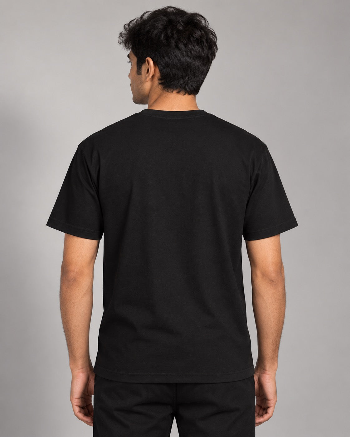 UNFKNBLVBL black tee on male model, plain back