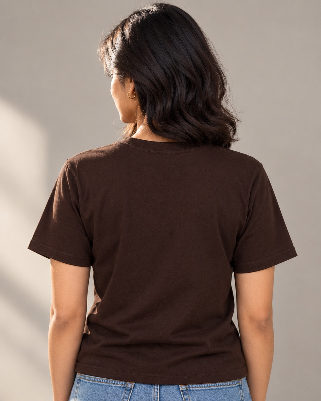 Plain back of the brown Wake Up and Smell the Coffee T-shirt on a woman
